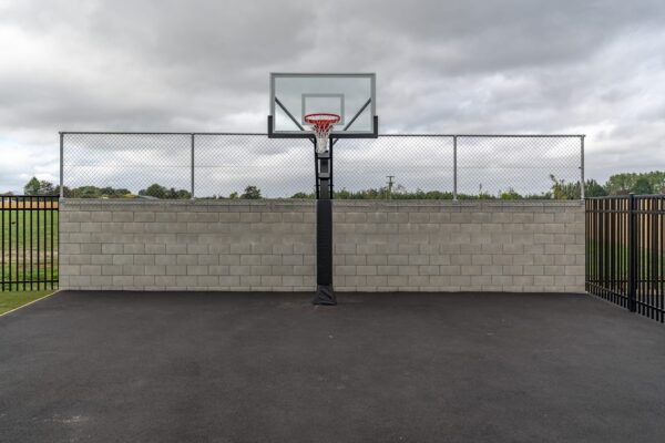 image of metal chainlink fencing installed behind basketball hoop by Axiom Built at Pītau-Allenvale School in Belfast, Christchurch