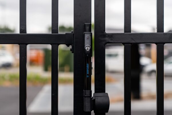 close up image of black lock and key security gate installed by Axiom Built at Pītau-Allenvale School in Belfast, Christchurch