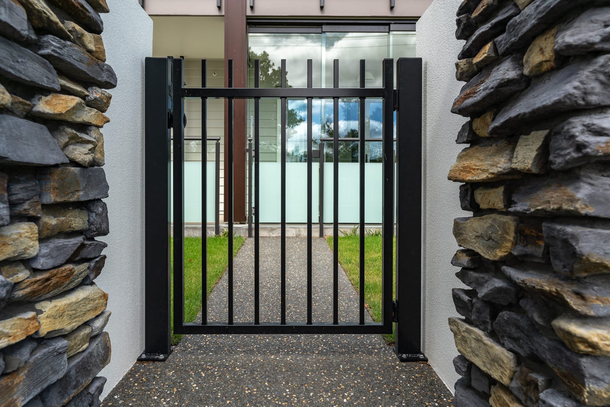 image of black metal security gate installed at Oceania Bellevue healthcare facility in Redwood designed, and installed by Axiom Built