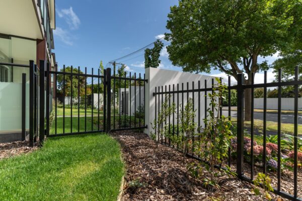 image of black metal boundary fence installed at Oceania Bellevue healthcare facility in Redwood designed, and installed by Axiom Built