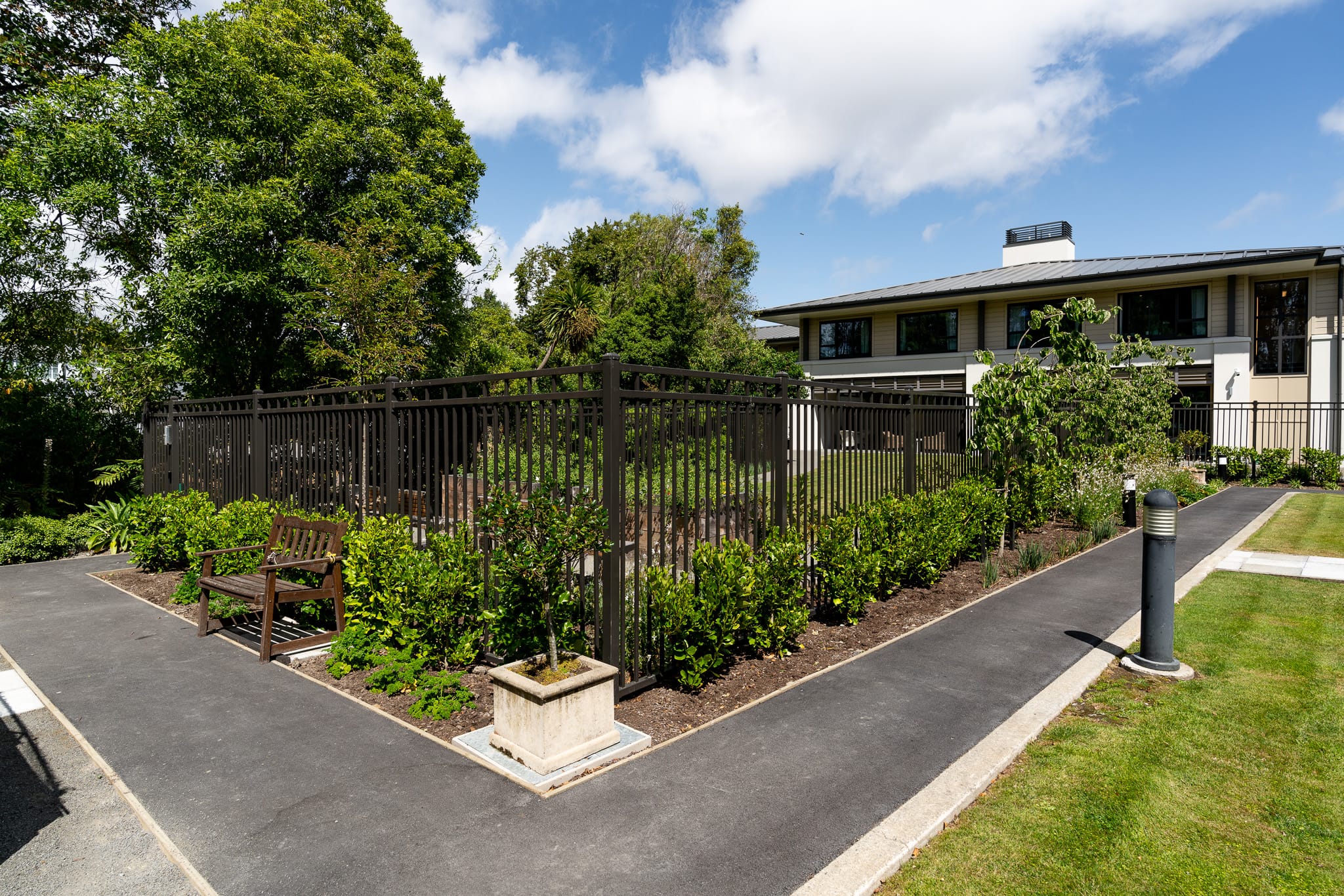 Black metal architectural fencing in garden designed, manufactured and installed by Axiom