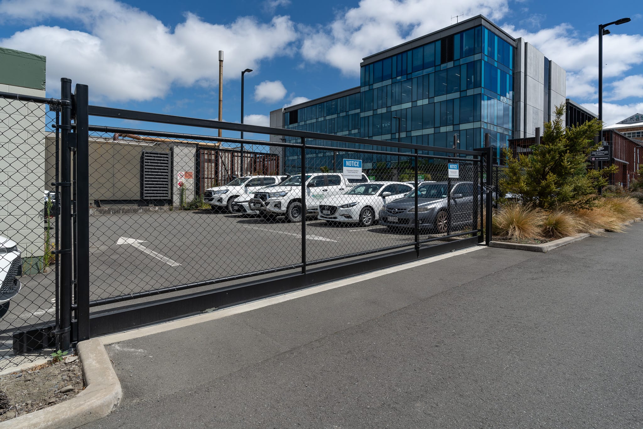 Black chainlink security gate for private parking designed and installed by Axiom Fencing, Balustrades & Gates in Christchurch NZ